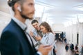 Passengers using their smartphones while standing in the subway crossing. Royalty Free Stock Photo