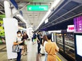 Passengers wait for the BTS Skytrain, an elevated rapid mass transit system