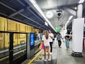 Passengers wait for the BTS Skytrain, an elevated rapid mass transit system Royalty Free Stock Photo