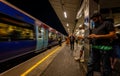 Passengers wait on a platform at London Bridge railway station, London UK