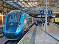 Passengers wait to board a TransPennine Express at Lime Street Station in Liverpool, UK. Royalty Free Stock Photo