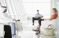 Passengers waiting in airport departure lounge