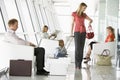 Passengers waiting in airport departure lounge