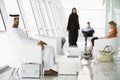 Passengers waiting in airport departure lounge