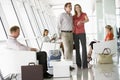 Passengers waiting in airport departure lounge