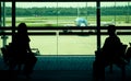 Passengers waiting at departure gate for boarding airplane Royalty Free Stock Photo