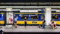 Passengers waiting on a platform in Brussels Central station while a dutch train is stationing Royalty Free Stock Photo