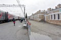 Passengers walk on the platform of the Ishim train station while the train was parking on a cloudy spring day. Tyumen region.