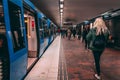 Passengers walking on the platform at GÃÂ¤rdet with a subway train waiting with the doors open Royalty Free Stock Photo