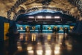 Passengers walking on the waiting subway at the underground station