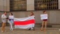 Passer took photo protest Belarusians wall building hands white-red-white flag