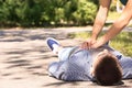 Passerby performing CPR on unconscious man