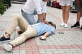 Passerby performing CPR on unconscious young man outdoors. First aid Royalty Free Stock Photo