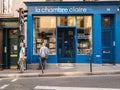 Passerby studies photography bookshop window display, Paris