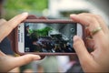 A Passerby Uses A Smartphone To Capture An Army Event