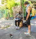 Passerby watches steel drum player in Paris