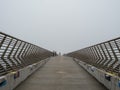 Passerbys on a pier on a fooy day Royalty Free Stock Photo