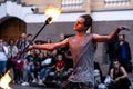 Passers-by became spectators of the street fire show. A young man is holding a stick with lights. Saint-Petersburg Royalty Free Stock Photo