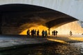 Passersby walking under Iena bridge, Seine river, Paris