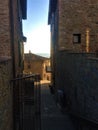 Passignano sul Trasimeno ancient town, Umbria region, Itlay. Ancient alley, arch and flowers Royalty Free Stock Photo