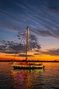 A Decorated Sailboat Cruises Past a Florida Sunset/Boat Parade Royalty Free Stock Photo