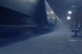 Passing cargo train in blurred motion at train station on a winter night Royalty Free Stock Photo
