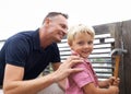 Passing down the knowledge of my many skills. A handsome father teaching his son how to use a hammer.