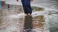 Passing through flooded roads on foot with still rainy conditions