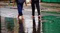 Passing through flooded roads on foot with still rainy conditions