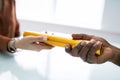 Passing Golden Relay Baton To Other Person Royalty Free Stock Photo