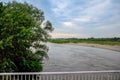 Passing over the bridge over river. The landscape of the river, the surface and the trees of the river\'s waterplain Royalty Free Stock Photo