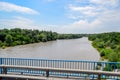 Passing over the bridge over river. The landscape of the river, the surface and the trees of the river\'s waterplain Royalty Free Stock Photo