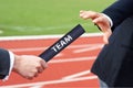 Passing team baton in relay race business men hand over