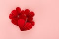 Passion bright red paper ribbed heart shape of hearts on soft light pink background, top view, copy space. Valentine day.