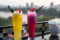 Passion fresh fruit juice with ice on outdoor table in cafe and bar. Pineapple and red dragon fruit. Urban lake on background Royalty Free Stock Photo