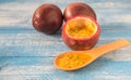 Passion fruit,Blue wooden floor.Wooden spoon. Royalty Free Stock Photo