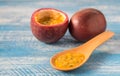 Passion fruit,Blue wooden floor.Wooden spoon. Royalty Free Stock Photo