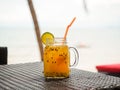 Passion fruit juice in glass with slices of lime on the table,refreshment drinks,cold and fresh