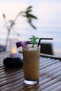 Passion fruit juice is placed on a wooden table, twilight sea background