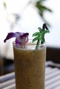 Passion fruit juice is placed on a wooden table, twilight sea background