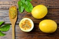 Passion fruit pulp on the wooden spoon next to passion fruit on wooden table Royalty Free Stock Photo