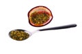 Passion fruit seeds on a spoon isolated on white Royalty Free Stock Photo