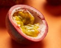 Passion fruit whole half isolated on orange background