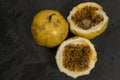Passion fruit, whole and sliced, on black stone table Royalty Free Stock Photo