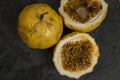 Passion fruit, whole and sliced, on black stone table Royalty Free Stock Photo