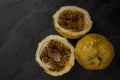 Passion fruit, whole and sliced, on black stone table Royalty Free Stock Photo