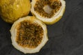 Passion fruit, whole and sliced, on black stone table Royalty Free Stock Photo