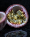 Passion Fruits close up on black stone background Royalty Free Stock Photo