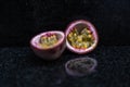 Passion Fruits close up on black stone background Royalty Free Stock Photo