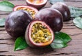 Passion fruits and its cross section with pulpy juice filled with seeds. Wooden background Royalty Free Stock Photo